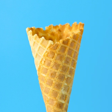 An ice cream cone with a light blue background