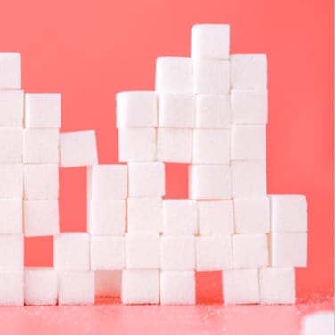 Sugar cubes grid with a pink background